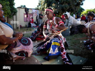 a-female-sangoma-speaks-to-teacher-lucy-thembani-during-initiation-D98715
